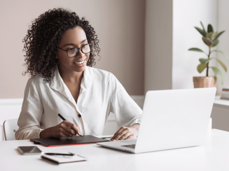 A female property manager looks for talent using a laptop. 